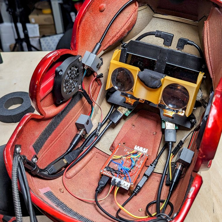 Inside the helmet: the sensor board and hand-wired perfboard alongside the display mount, speaker and camera modules